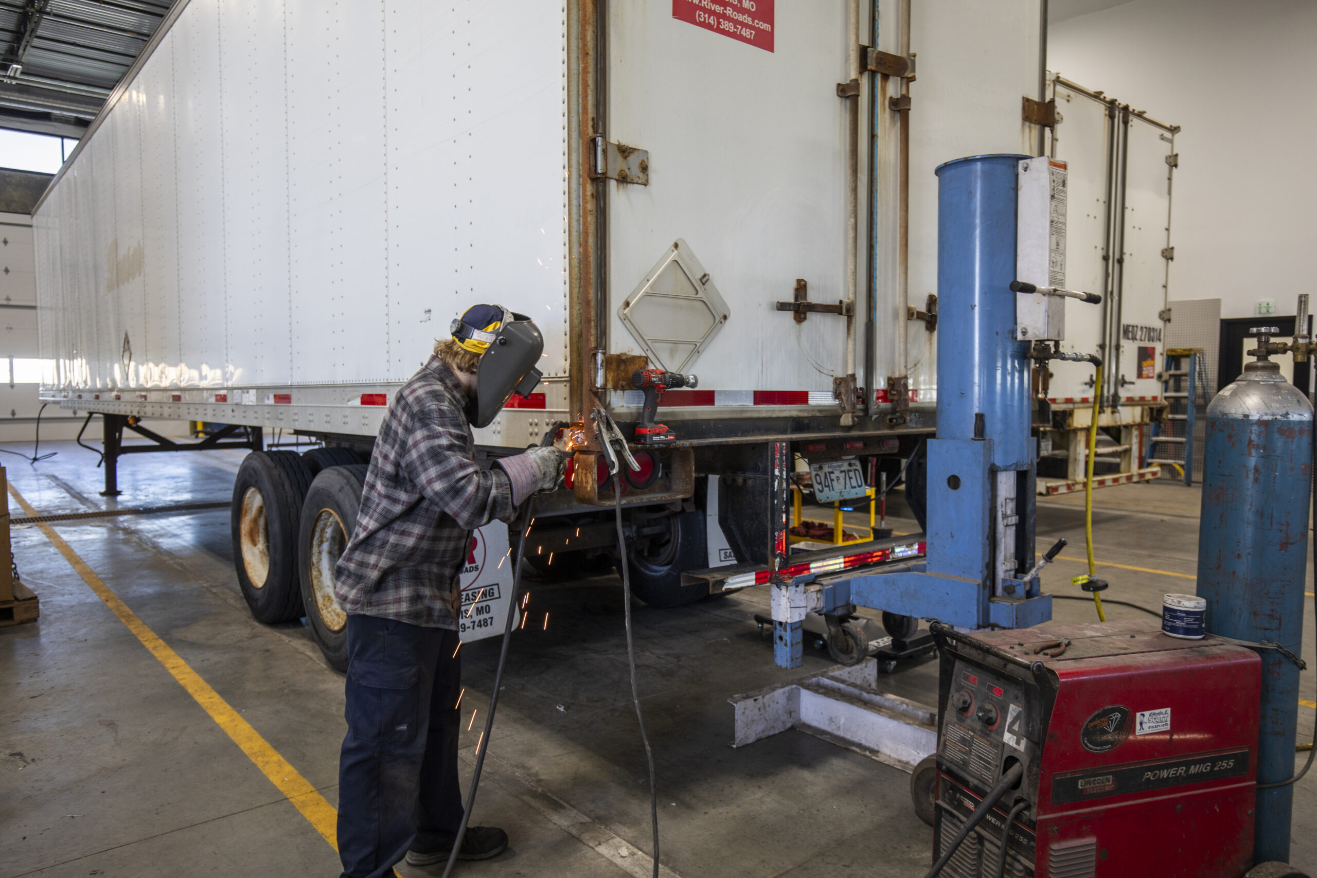 Trailer repair technician welding on a Dry Van